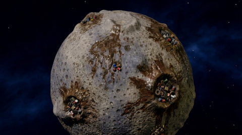 Official promotional art: the Moon seen from space with brown dirt streaks and small colourful buildings in several craters