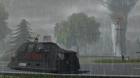 Promotional art: a black armoured vehicle marked APM 2021 drives along a wet road in heavy rain while a tornado touches down behind a farm windmill
