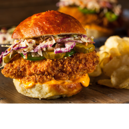 cajun chicken sandwich with an iced tea and fries