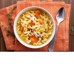 Chicken noodle soup with soda on the side